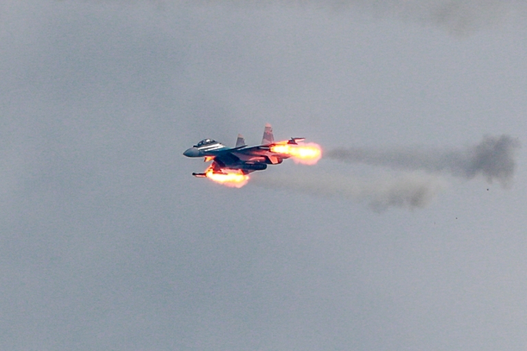 На фото: истребитель Су-35 (Су-35С) в момент ведения огня из своей бортовой пушки.